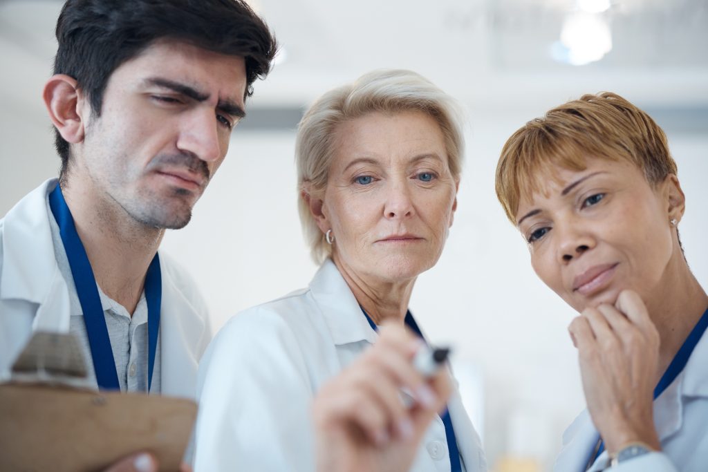 Doctor, serious team and thinking in strategy or healthcare for schedule planning or brainstorming