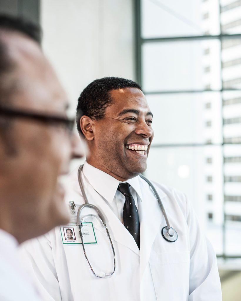 Black man doctor in lab coat with a stethescope. Black man doctor in lab coat with a stethescope.